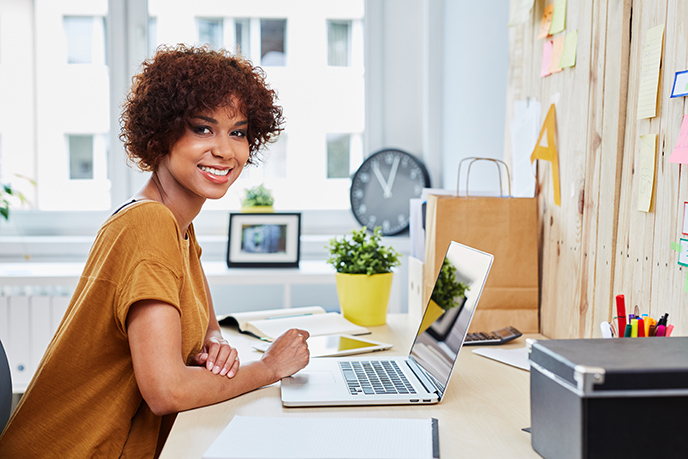 Woman Entrepreneur Sitting At Desk Viewing Pricing